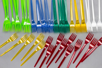 Colorful plastic forks on gray backgroud