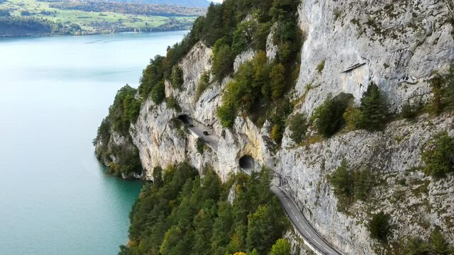 Panoramic street along Lake Thun in Switzerland - aerial drone footage at Beatenbucht
