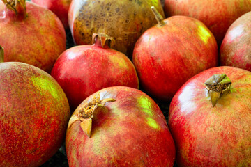 Pomegranate natural background with close up on a ripe granates ready for juice press.