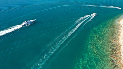 Fototapeta premium Aerial drone photo of small luxury yacht with wooden deck cruising near tropical exotic port
