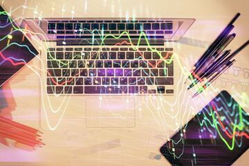 Multi exposure of forex chart drawing over table background with computer. Concept of financial research and analysis. Top view.
