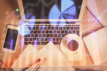 Stock market chart and top view computer on the table background. Double exposure. Concept of financial analysis.