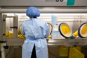 Black healthcare worker handling hazardous drugs for patient at hospital