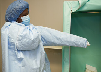 Black healthcare worker wearing PPE safety equipment
