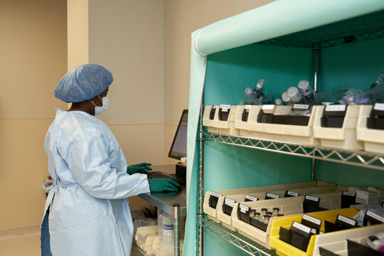 Healthcare worker logging medicines on computer