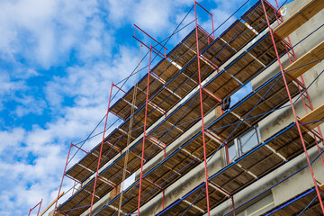 Metal and wooden girder scaffolding providing platforms for building construction.