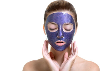 Young woman with violet shiny glamor face mask on her face.