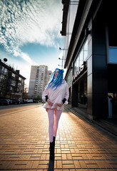 Glamorous girl with dreadlocks on the street near the business center