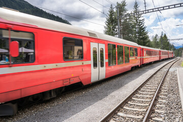 Fototapeta premium Regional train comes to the station, Switzerland