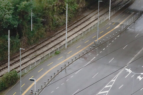 Boulevard in Sofia Bulgaria in rain no cars tramway tracks bicycle road bus stop car road street marking with a road for pedestrians
