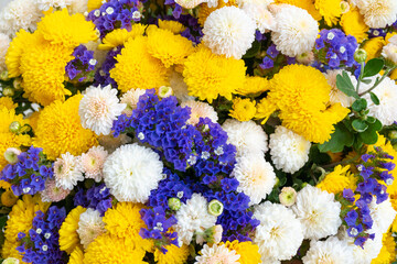 Floral background. A huge bouquet of autumn flowers of yellow, biolet and white or beige