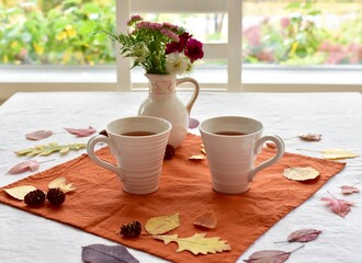 Warm fall beverage of hot tea with autumn leaves decor to sip and enjoy on cool seasonal days...