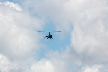 Fototapeta na wymiar A helicopter flying in a cloudy sky in regional Australia