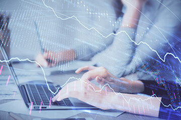 Multi exposure of woman hands typing on computer and financial chart hologram drawing. Stock market...