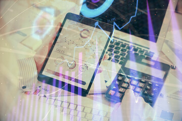 Double exposure of man's hands holding and using a digital device and forex graph drawing. Financial market concept.