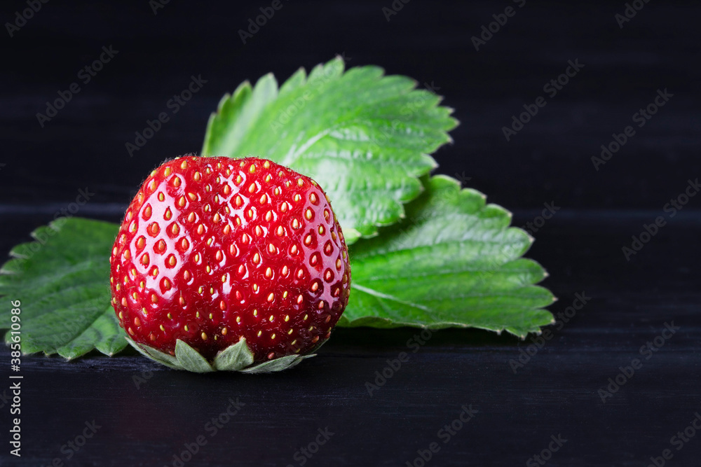 Wall mural fresh red strawberries on a dark wood background. place for text