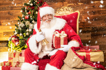 Fototapeta na wymiar Real Santa Claus Sitting Near Christmas Tree with gifts.
