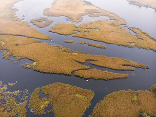 Aerial Shot of the Misty Autumn Floodplains of the Dnieper River with Reed islands in the river