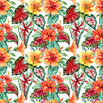 Seamless pattern of tropical flowers and leaves on a white background. Yellow and orange hibiscus and Caladium leaves,
  floral tropical print for fabric, home furnishings decor and various designs.