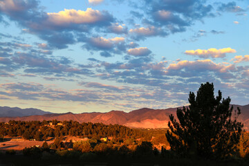 Orange golden hour sunshine on the foothills of the Rock Mountains in Colorado Springs USA with...