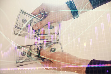 Multi exposure of financial graph drawing hologram and USA dollars bills and man hands. Analysis concept.