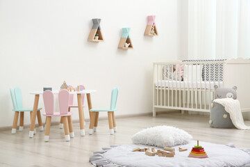 Cute baby room interior with cot and little table