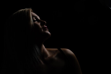 Obraz premium Black and white glamor woman portrait, dark beautiful face, female isolated on black background, stylish sexy look, young lady studio shot