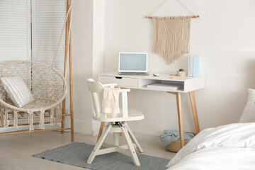 Stylish room interior with workplace and hanging chair