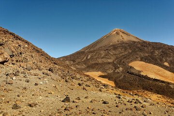 Landscape from Tenerife Canary Islands, view to the volcano Pico del Teide, deserts and semi-deserts in the dry mountains. Blue sky, rocky and vulcanic surface