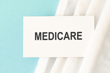 Word medicare with medical mask on a blue background. Medicine concept