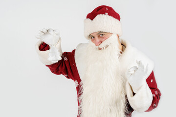 Santa Claus holds a Christmas tree toy in his hands. Isolated on white