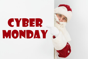 Santa Claus points his fingers at the board with the text - CYBER MONDAY