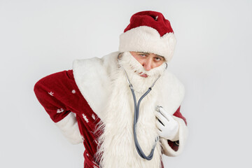Santa Claus holds a stethoscope in his hand - listens to his heart. Isolated on white