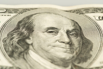 macro of 100 dollar bill with Benjamin Franklin