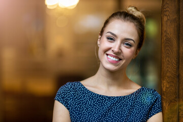 Portrait of confident female entrepreneur standing at creative office
