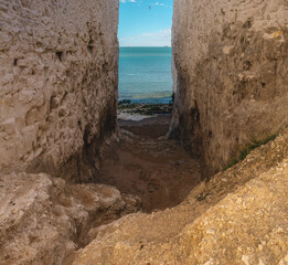 Empty Kingsgate Beach, walking through the chalk stacks clifs at Botany Bay in Kent, England.
