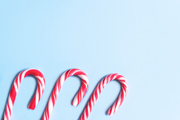 Candy cane on a blue background. Christmas ornaments.