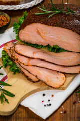 Roasted Turkey Breast Cajun Style Deli Lunch Meat on Old Wooden Background. Selective focus.
