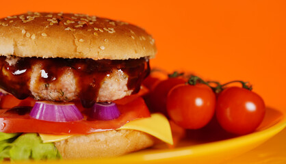 Hamburger or sandwich. Delicious sandwich hamburger with meat, cheese and fresh vegetable. Hamburger or sandwich is the popular fast food for brunch or lunch. Juicy cheeseburger