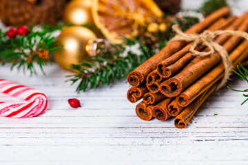 Christmas Holidays Composition Cinnamon and Christmas Decoration on White Wooden Background. New Year Concept and Christmas banner. Selective focus.