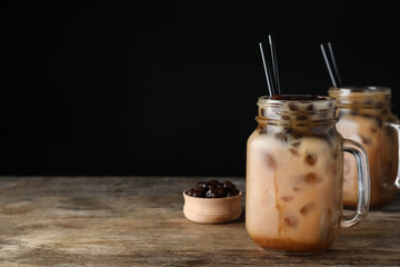 Tasty milk bubble tea on wooden table. Space for text