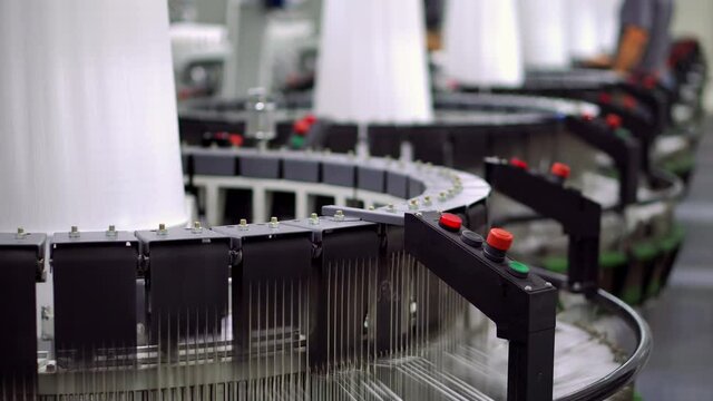 Production of white polypropylene flat yarn for the production of industrial bags. Allison-circular loom woven bag machine. Production of polypropylene sleeves. Shuttle.