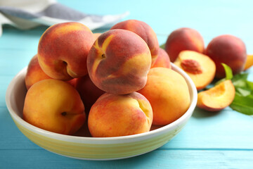 Fototapeta na wymiar Fresh sweet peaches on turquoise wooden table, closeup