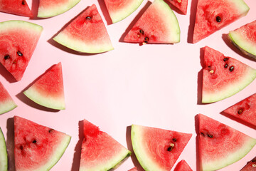 Frame of watermelon slices on pink background, flat lay. Space for text