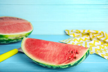 Yummy cut watermelon on light blue wooden table