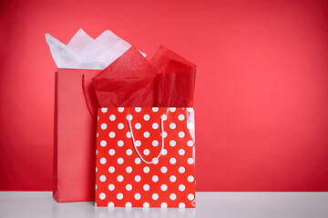 Shopping bags with paper on red background