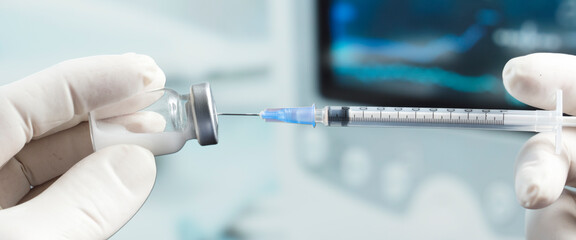 Doctor or nurse with flu vaccine, syringe for measles injection prepares for vaccination of babies and adults, medicine and drug concept, clinical background