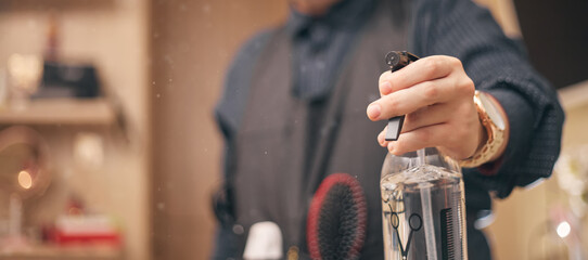 hairdresser, barber in an apron on a light background