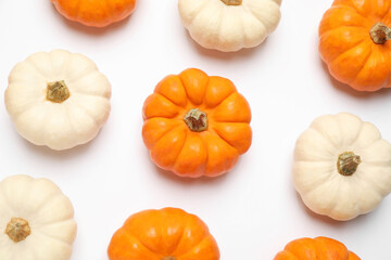 Different ripe pumpkins on white background, top view