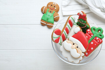 Decorated Christmas cookies on white wooden table, flat lay. Space for text